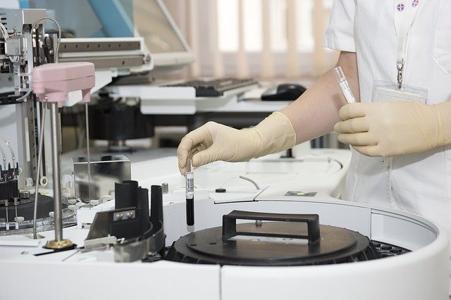 Healthcare industry person using blood testing machine for training