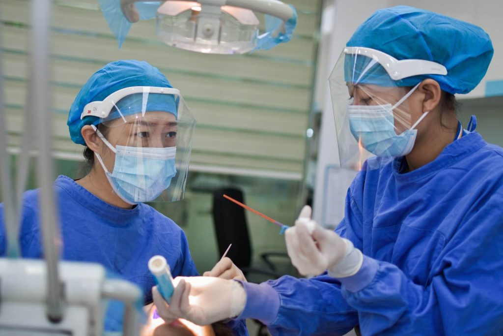 Two healthcare professionals in blue coats