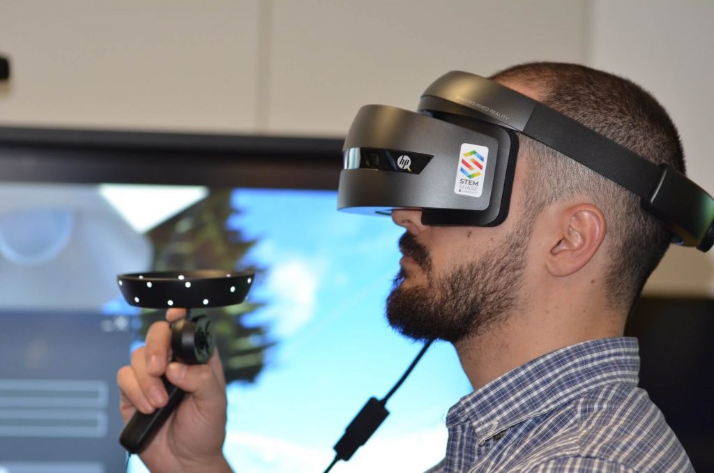 Man using virtual reality headset for distance learning