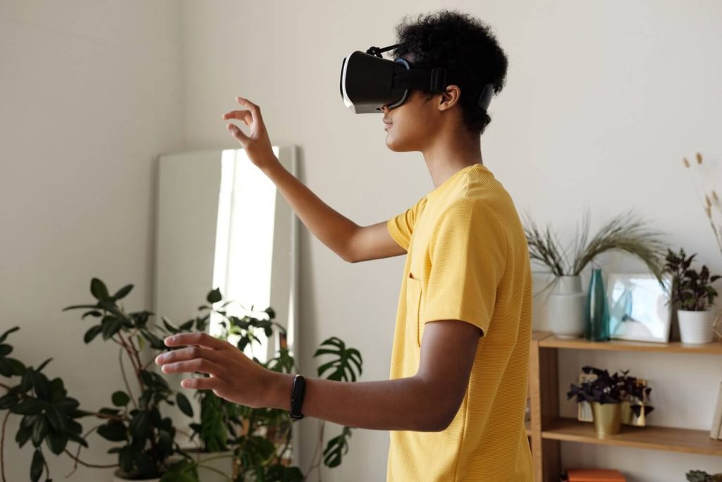 Boy using VR headset as part of modern education process