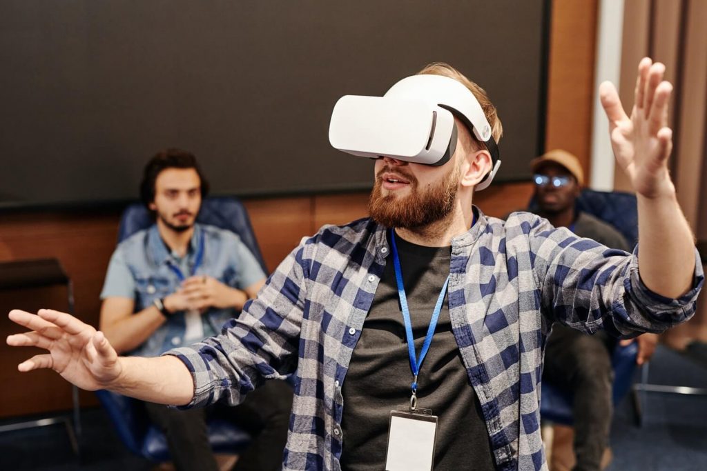 A man is using a VR device for corporate training in virtual reality