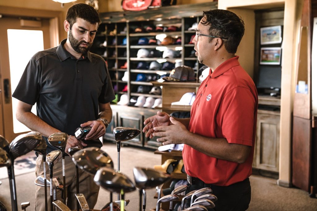 A man selling golf clubs